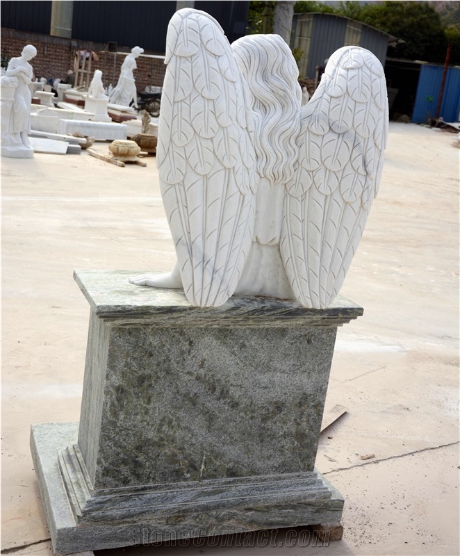 Angel Carving Sitting On Headstone In White And Green Marble
