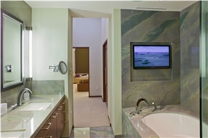 Exotic Gaya Quartzite Installed Throughout Bathroom Floors, Walls and Countertops