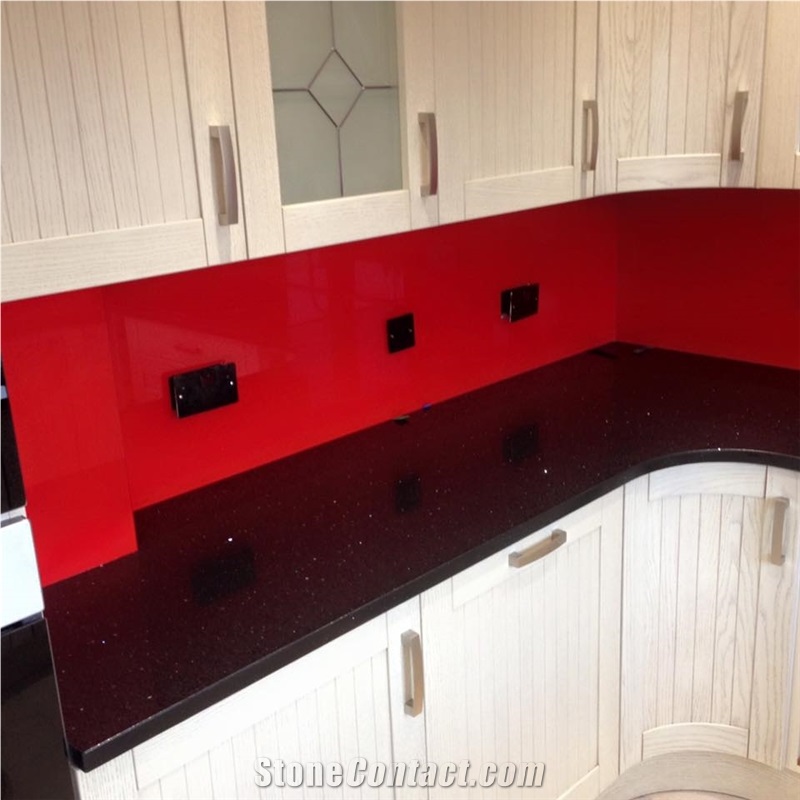 Red Glass Splashback On Black Sparkling Quartz Countertop From