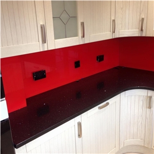 Red Glass Splashback on Black Sparkling Quartz Countertop