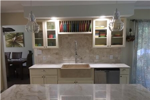 Quartzite Countertops Are Complimented with Beveled Marble Tiles in the Backsplash