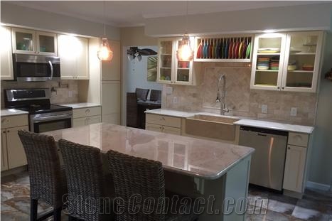 Quartzite Countertops Are Complimented with Beveled Marble Tiles in the Backsplash
